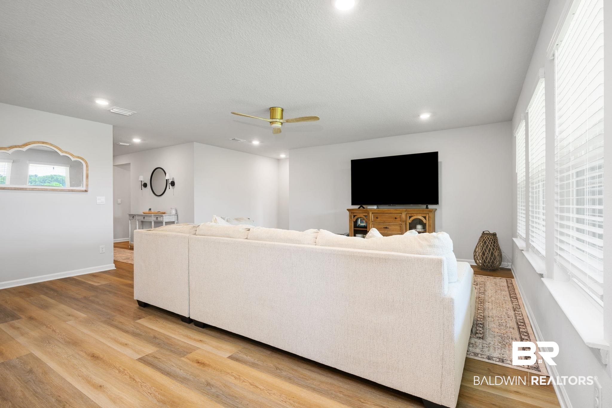 8021 Valor Rdg Way North Mobile, AL 36619 - Photo 23 of 34 Spacious living area featuring wood-finish flooring, recessed lighting, and a gold-tone ceiling fan
