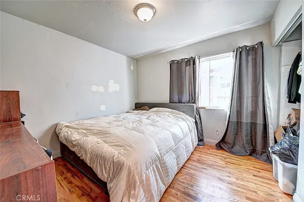 a bed sitting in a bedroom next to a window
