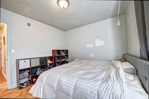 a bed sitting in a bedroom next to a window