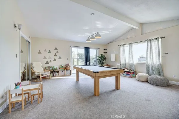 a living room with furniture a large window and work space