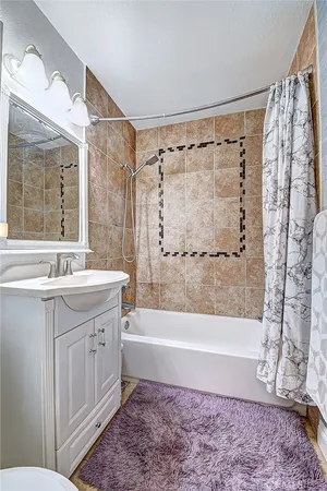 a bathroom with a bathtub a sink a vanity and a shower