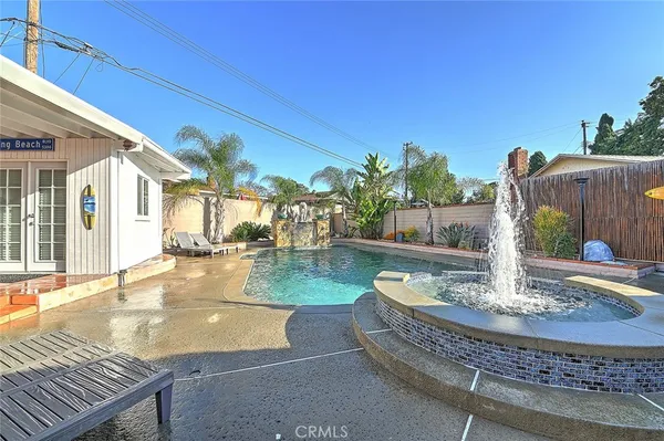a view of a backyard with swimming pool