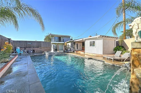 a view of a house with backyard and sitting area