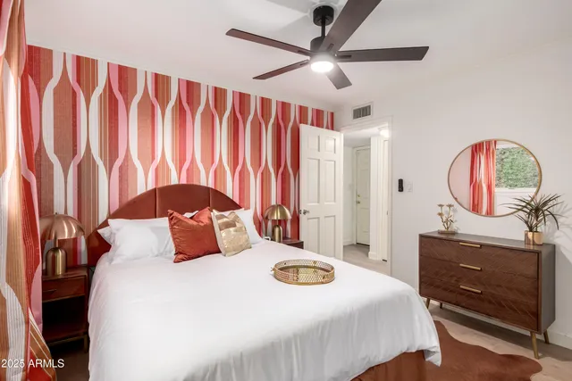 a living room with furniture a flat screen tv and a chandelier