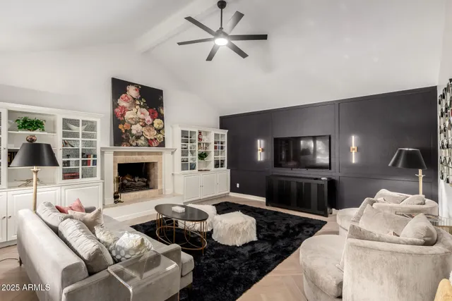 a living room with patio furniture and a potted plant