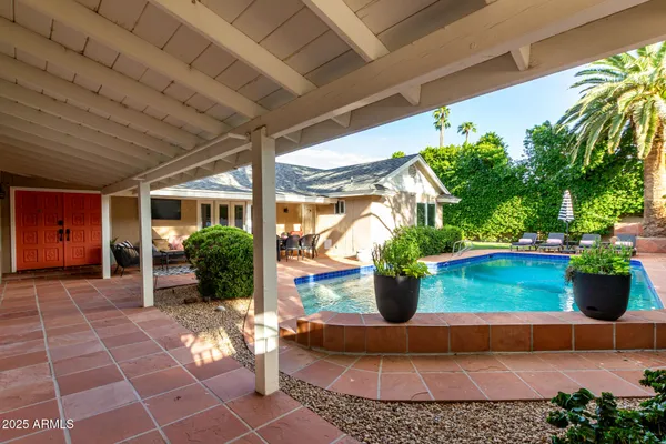 an aerial view of a house with a yard basket ball court and outdoor seating