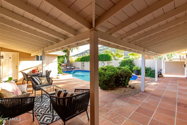 a view of a house with a yard and potted plants