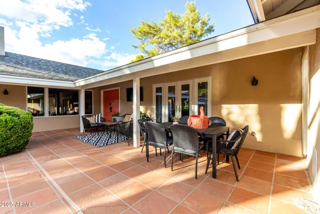 an aerial view of a house with swimming pool and large trees