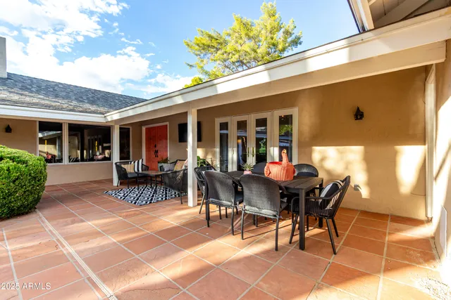 a view of a house with a yard and potted plants
