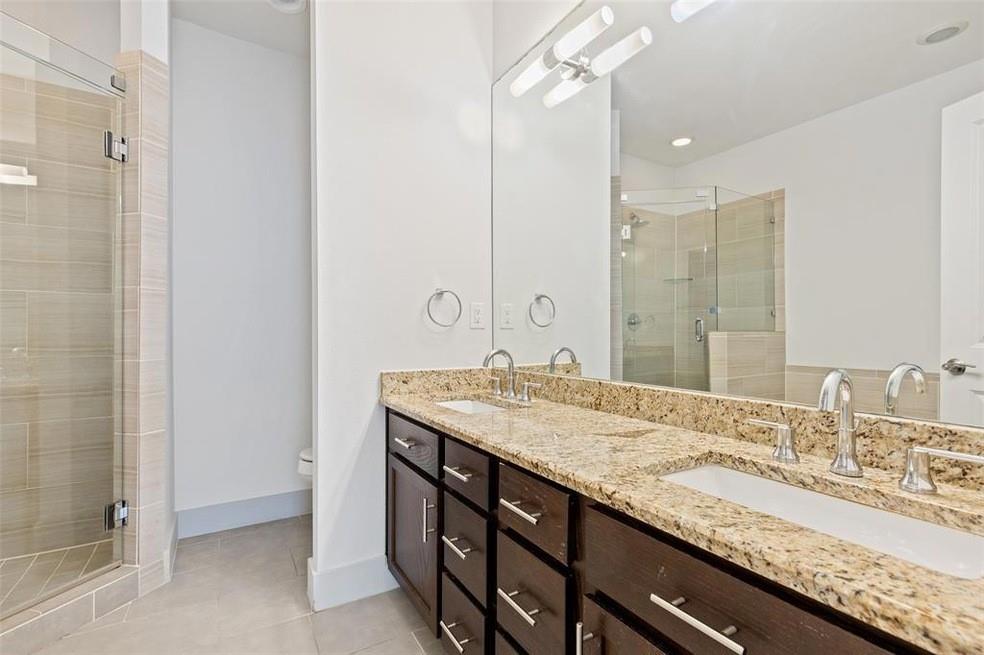 5924 Hudson Street, Unit F Dallas, TX 75206 - Photo 18 of 25 a bathroom with a granite countertop sink and a mirror