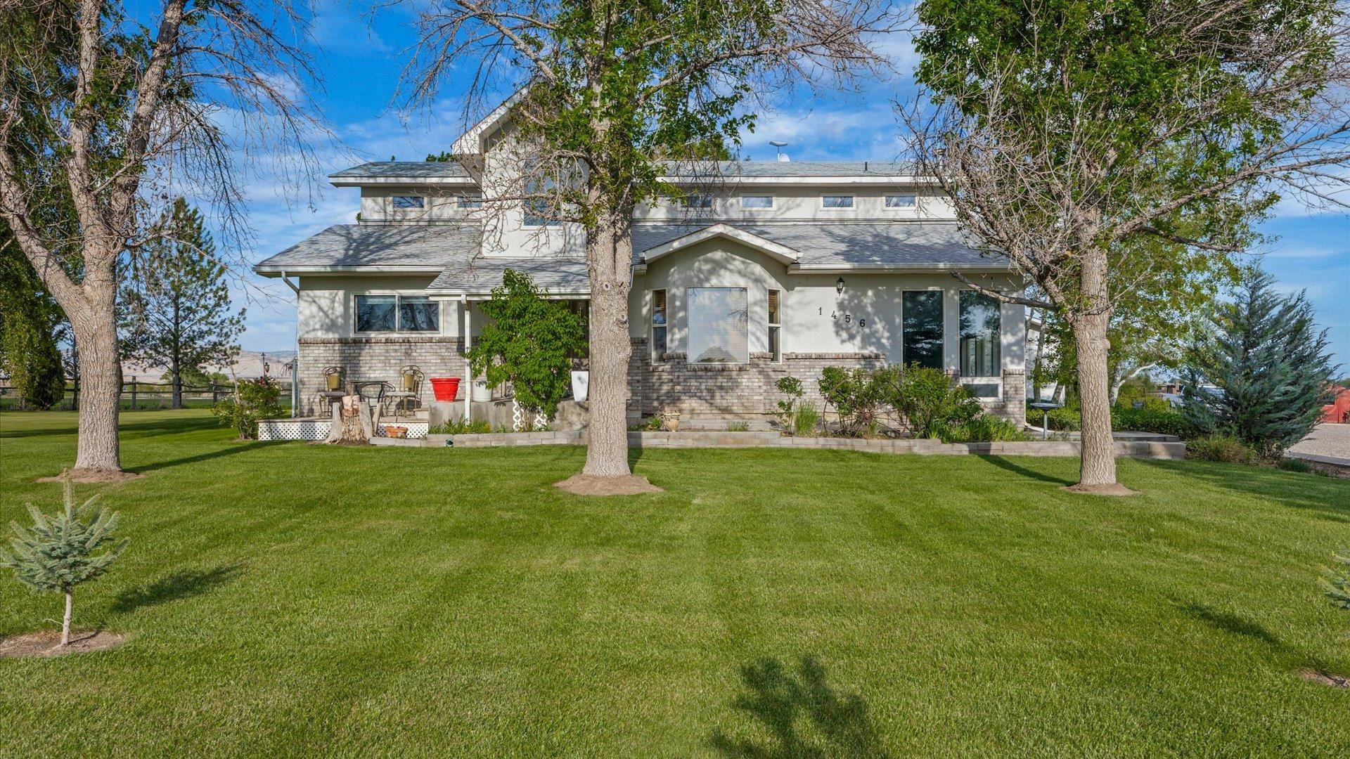 1456 17 Road Fruita, CO 81521 - Photo 1 of 42 a front view of a building with garden