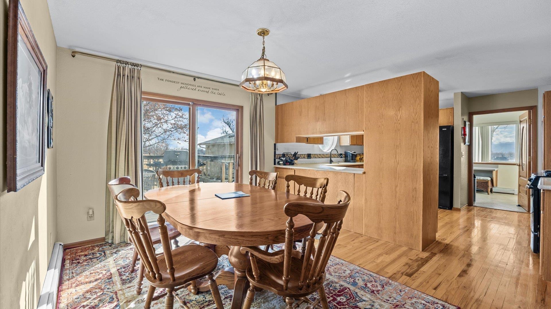 1456 17 Road Fruita, CO 81521 - Photo 11 of 42 a dining room with furniture a chandelier and wooden floor