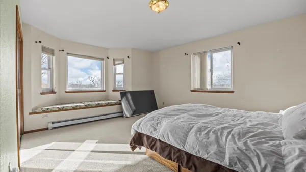 a bedroom with a bed and dresser