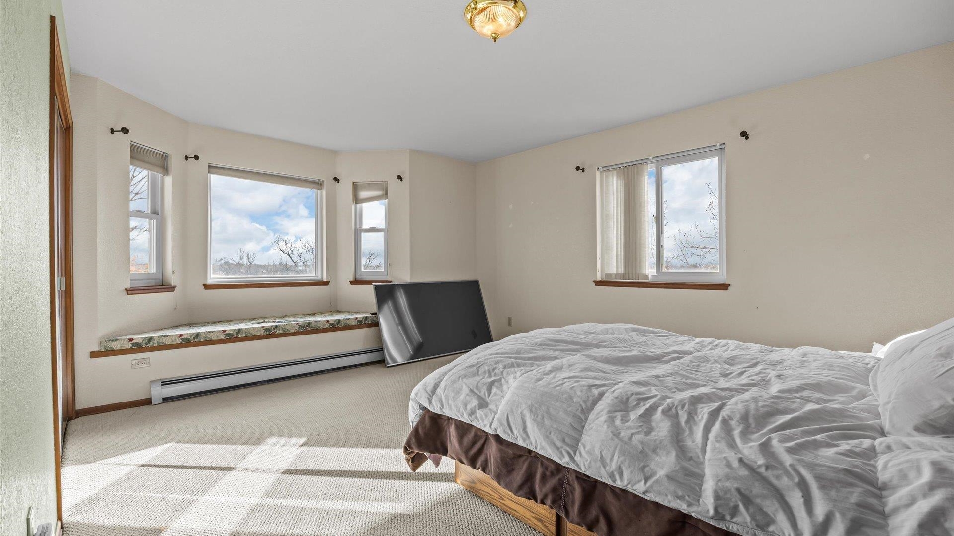 1456 17 Road Fruita, CO 81521 - Photo 14 of 42 a bedroom with a bed and a window with outer view