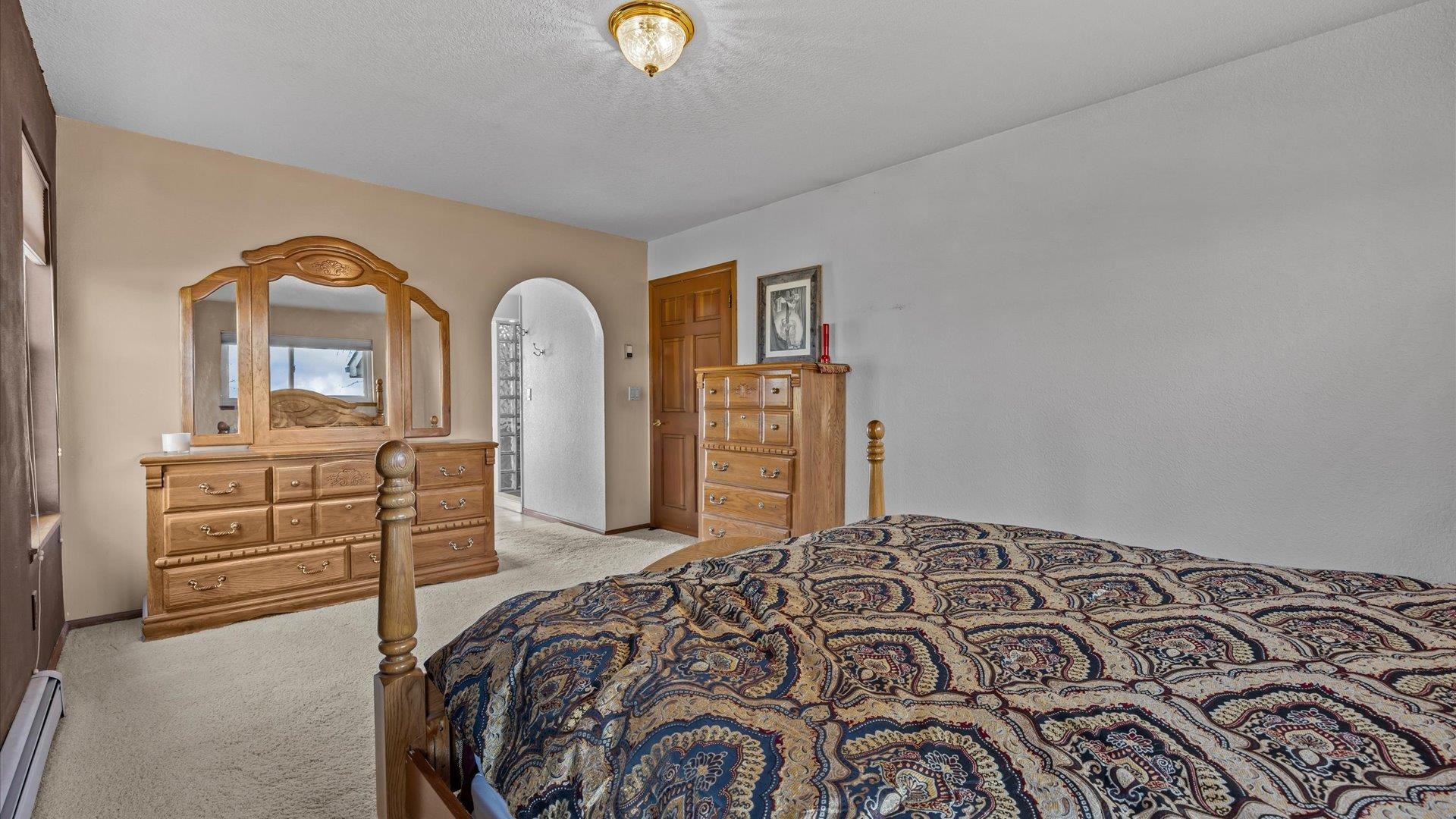 1456 17 Road Fruita, CO 81521 - Photo 20 of 42 a bedroom with a bed and dresser