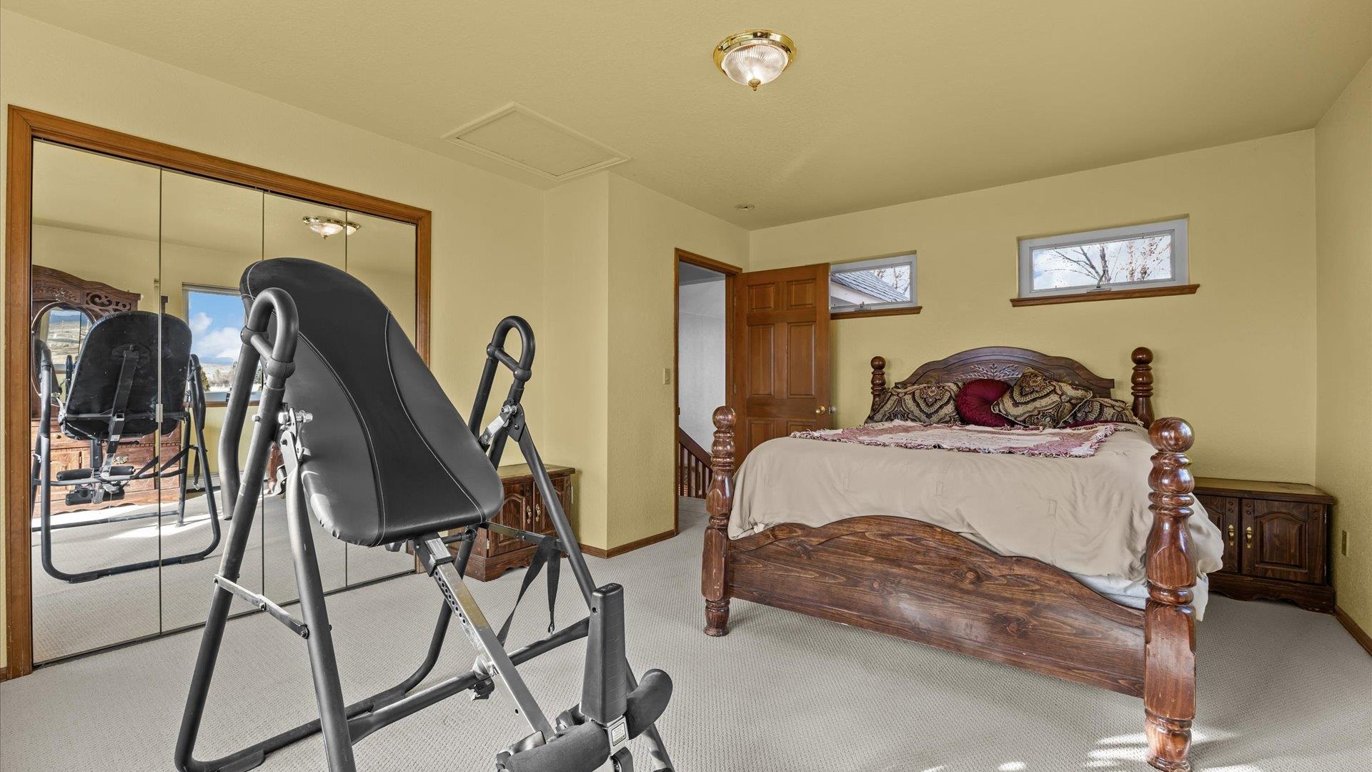 1456 17 Road Fruita, CO 81521 - Photo 24 of 42 a bedroom with a bed a desk and chair