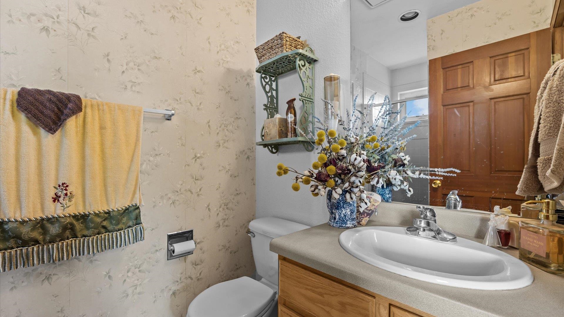 1456 17 Road Fruita, CO 81521 - Photo 26 of 42 a bathroom with a toilet sink and mirror