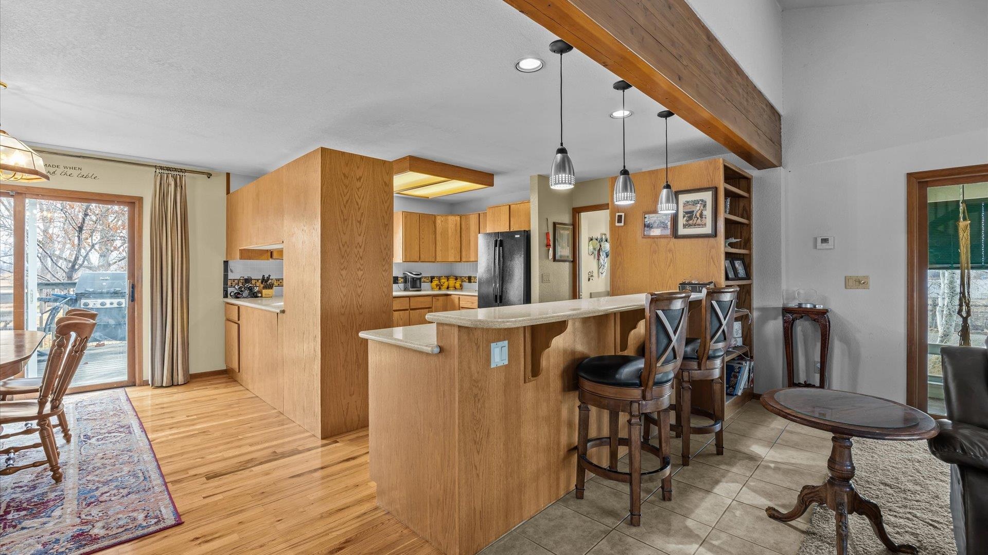 1456 17 Road Fruita, CO 81521 - Photo 9 of 42 a view of a dining room with furniture and wooden floor