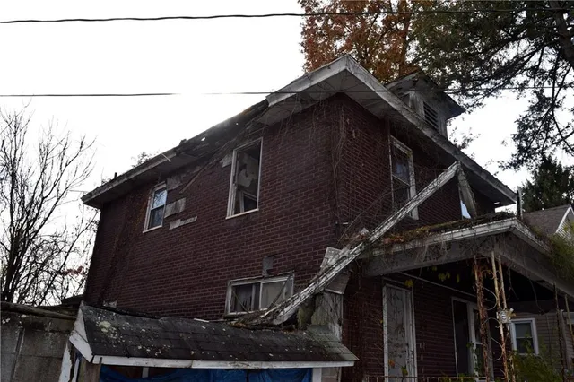 a tall building with a tree in the background