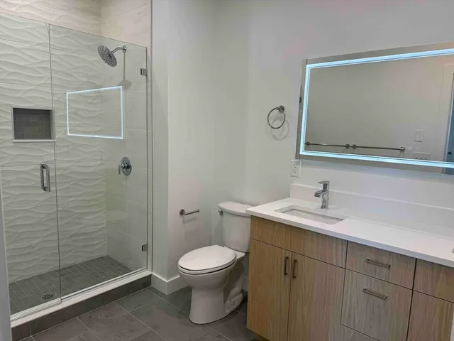 a bathroom with a toilet sink a shower and