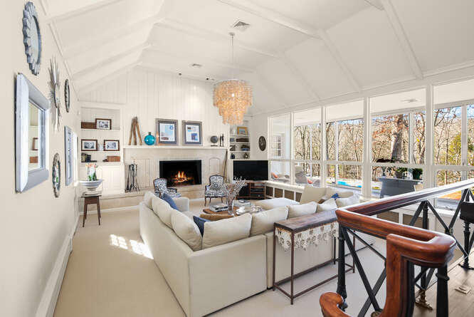 67 Hickok Road New Canaan, CT 06840 - Photo 2 of 56 a living room with furniture a fireplace and a large window