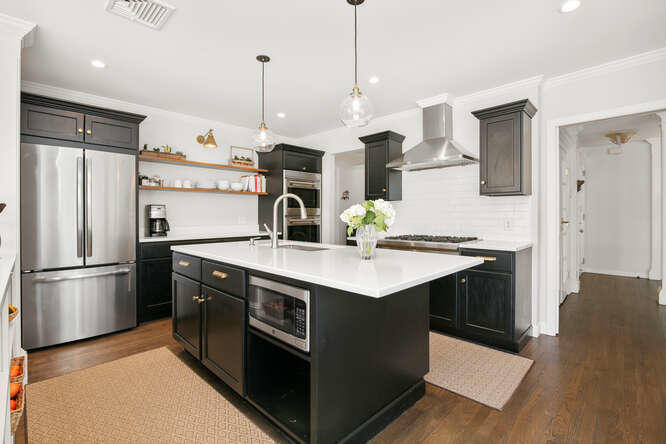 67 Hickok Road New Canaan, CT 06840 - Photo 11 of 56 a kitchen with kitchen island a sink stainless steel appliances and cabinets