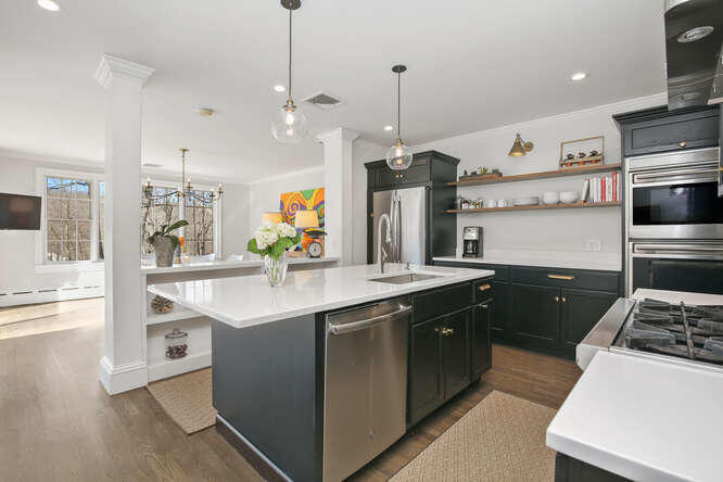 67 Hickok Road New Canaan, CT 06840 - Photo 12 of 56 a kitchen with stainless steel appliances granite countertop a sink a stove and a refrigerator