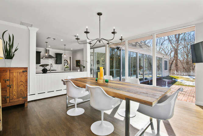 67 Hickok Road New Canaan, CT 06840 - Photo 14 of 56 a view of a dining room with furniture a chandelier and wooden floor