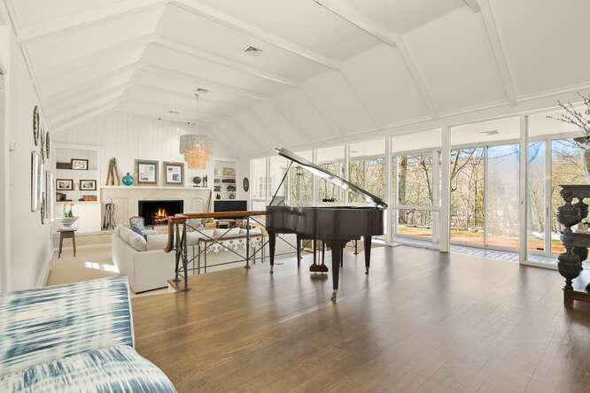 67 Hickok Road New Canaan, CT 06840 - Photo 3 of 56 a living room with furniture a wooden floor and a large window