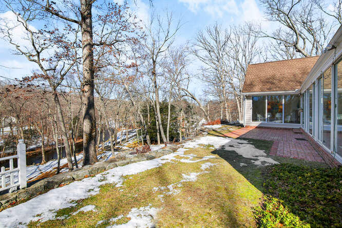 67 Hickok Road New Canaan, CT 06840 - Photo 22 of 56 a view of a house with snow on the background