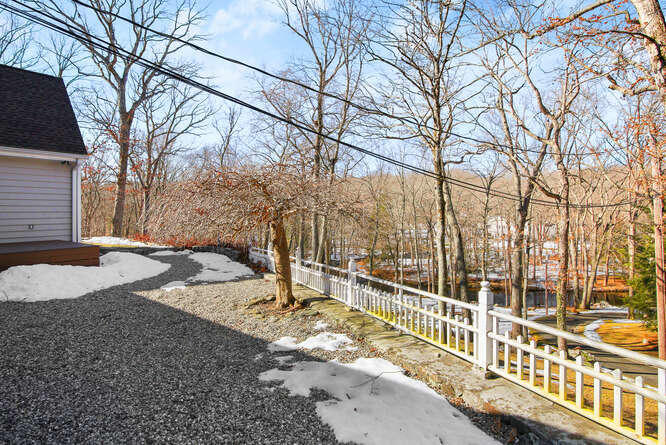 67 Hickok Road New Canaan, CT 06840 - Photo 23 of 56 a view of a house with a snow on the road