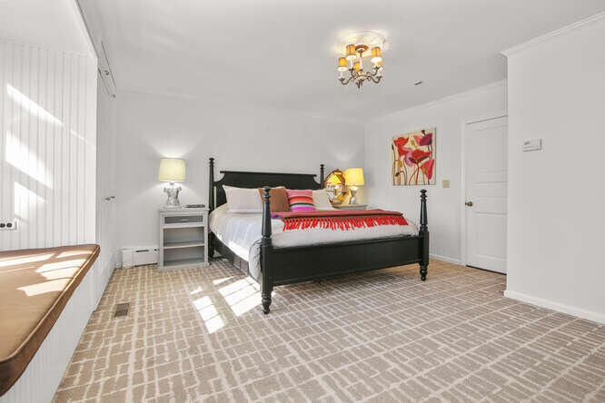 67 Hickok Road New Canaan, CT 06840 - Photo 36 of 56 a bedroom with a bed and a chandelier
