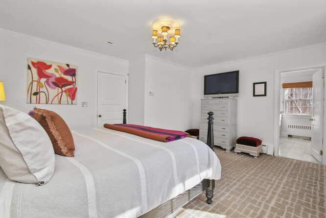 67 Hickok Road New Canaan, CT 06840 - Photo 37 of 56 a bedroom with a bed and a flat screen tv