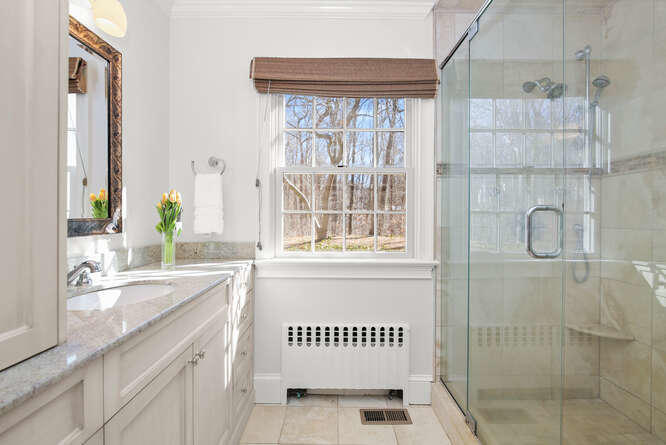 67 Hickok Road New Canaan, CT 06840 - Photo 38 of 56 a bathroom with a sink and a mirror
