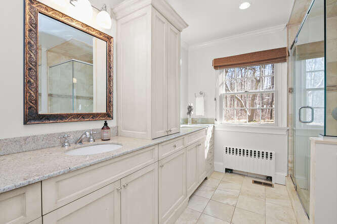 67 Hickok Road New Canaan, CT 06840 - Photo 39 of 56 a bathroom with a granite countertop sink and a window