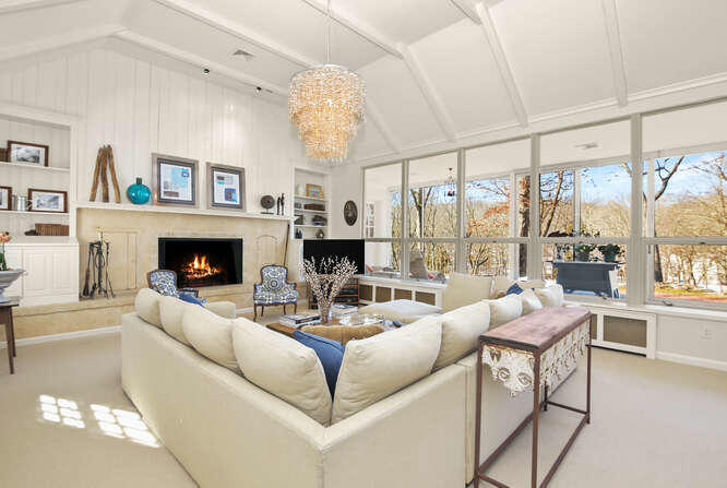 67 Hickok Road New Canaan, CT 06840 - Photo 5 of 56 a living room with furniture a fireplace and a large window