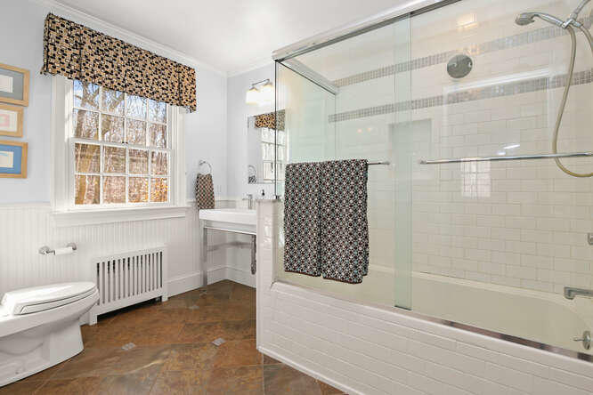 67 Hickok Road New Canaan, CT 06840 - Photo 45 of 56 a bathroom with a bathtub and a shower