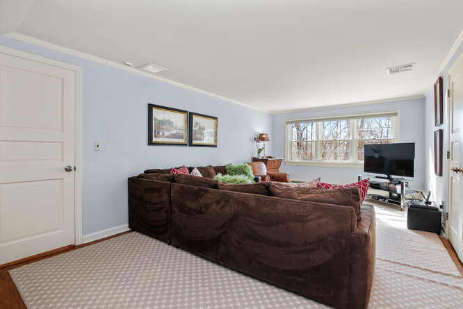 67 Hickok Road New Canaan, CT 06840 - Photo 48 of 56 a living room with furniture a flat screen tv and a window