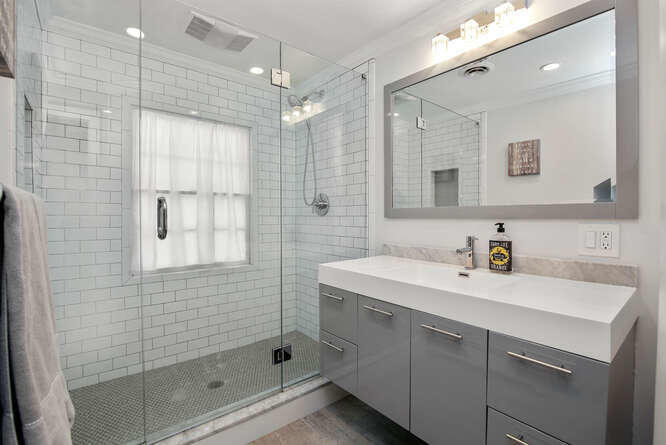 67 Hickok Road New Canaan, CT 06840 - Photo 49 of 56 a bathroom with a sink double vanity and shower