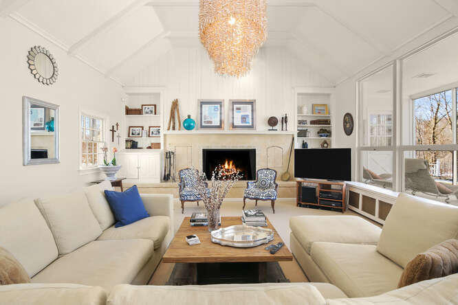 67 Hickok Road New Canaan, CT 06840 - Photo 6 of 56 a living room with furniture a flat screen tv and a fireplace