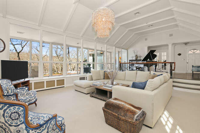 67 Hickok Road New Canaan, CT 06840 - Photo 7 of 56 a living room with furniture a flat screen tv and a large window