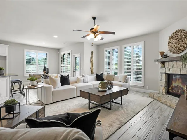 a living room with furniture kitchen view and a table