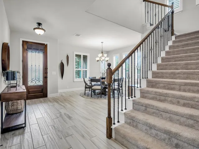 a view of entryway and hall with wooden floor