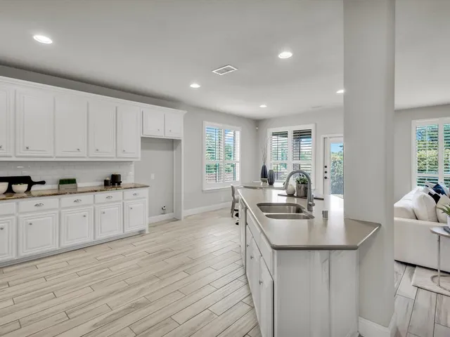 a kitchen with stainless steel appliances a sink stove and cabinets