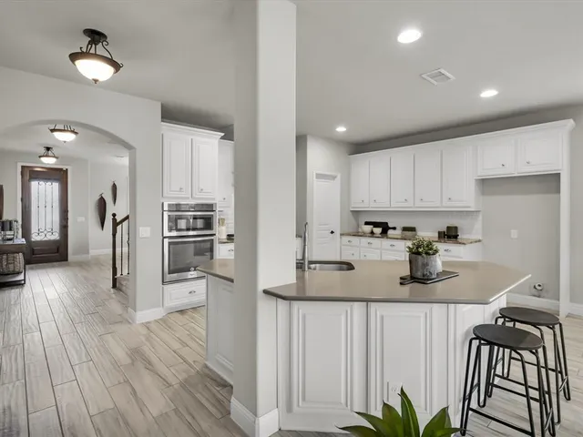 a kitchen with refrigerator and stove