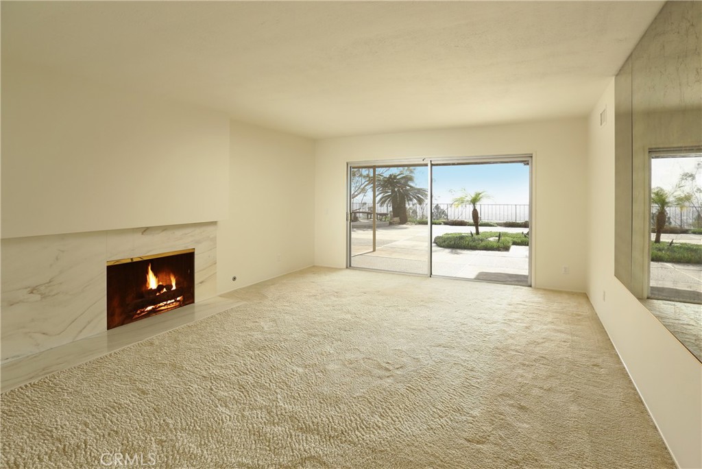 300 Wonderview Drive Glendale, CA 91202 - Photo 2 of 11 an empty room with a fireplace and windows