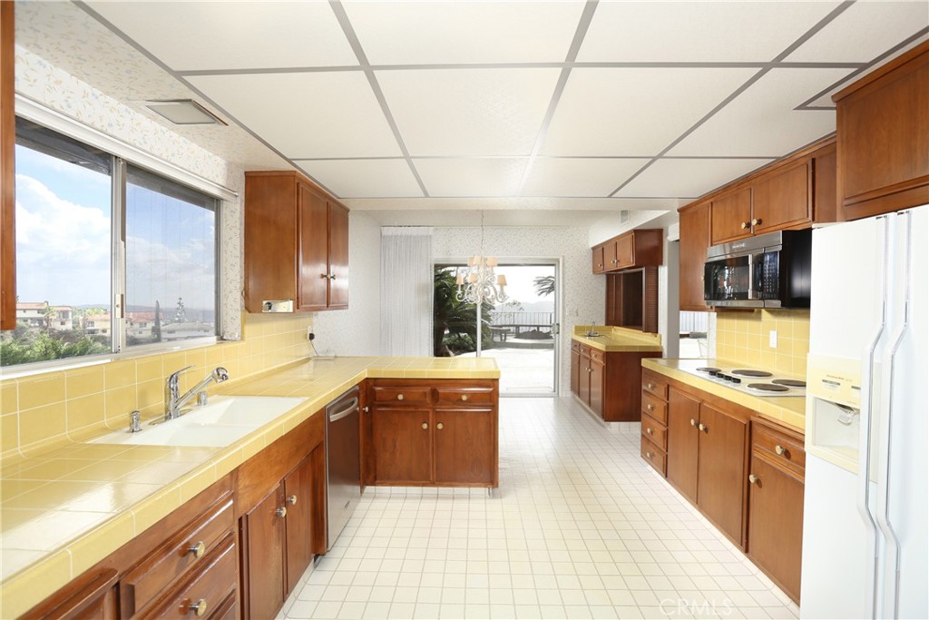 300 Wonderview Drive Glendale, CA 91202 - Photo 4 of 11 a large kitchen with kitchen island a large counter top space a sink a stove and refrigerator