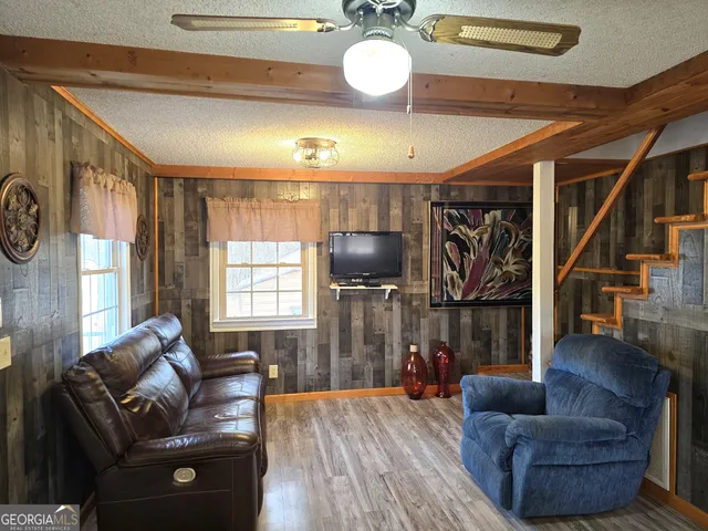 a living room with furniture and wooden floor