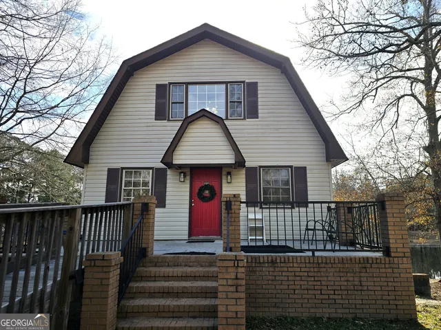 a view of a house with wooden fence