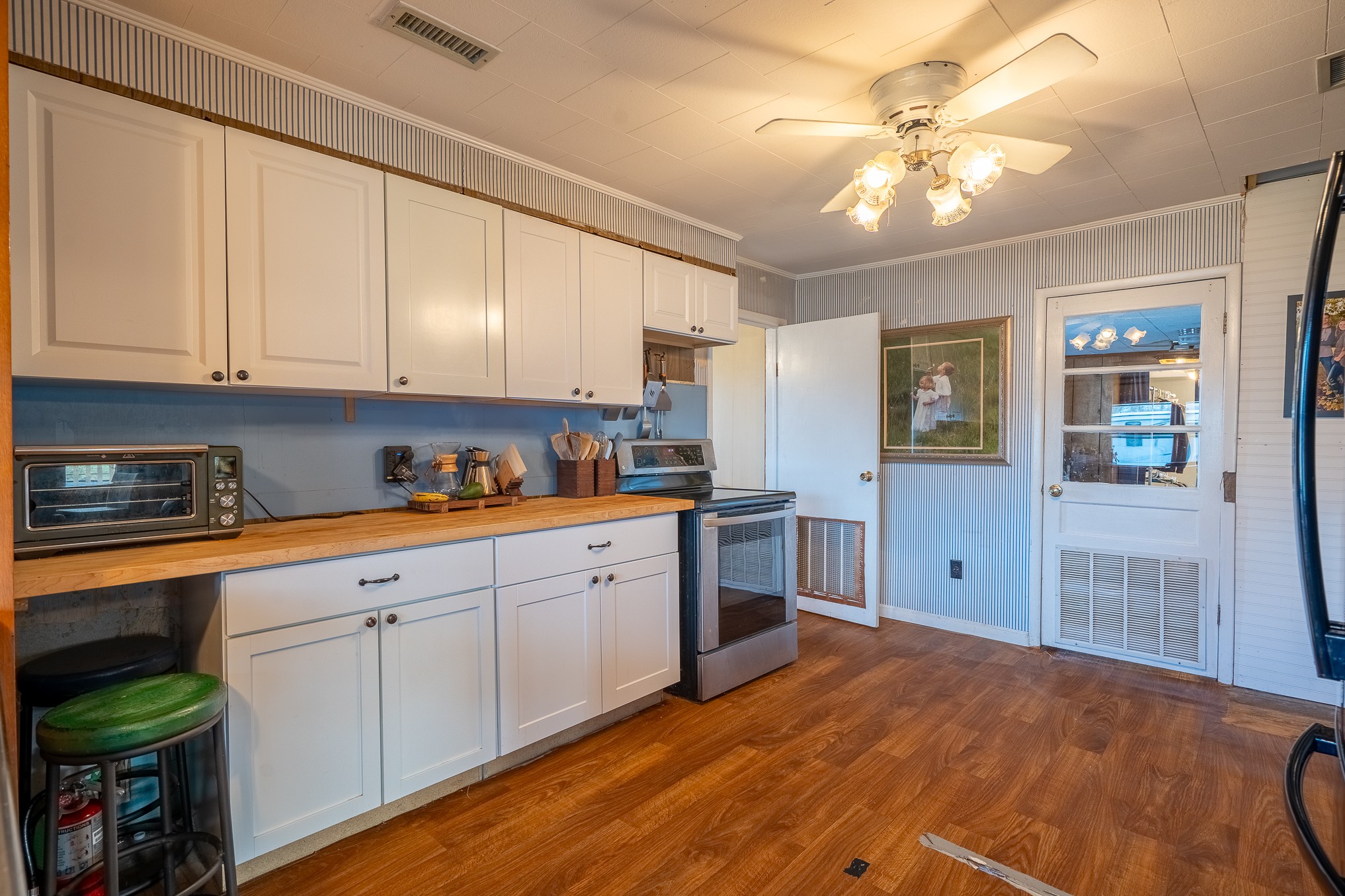 1545 Blue Springs Road Sparta, TN 38583 - Photo 69 of 99 a kitchen with stainless steel appliances granite countertop a stove top oven a sink dishwasher and white cabinets with wooden floor